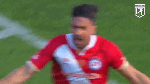 a soccer player wearing a red and white jersey with the letter s on the front