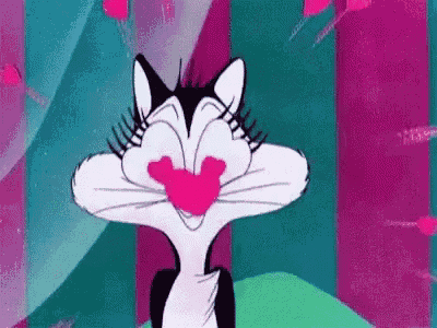 sylvester the cat from looney tunes is making a funny face with a pink heart in his mouth .