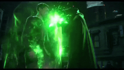 two men are standing next to each other with green lights coming out of their chests .