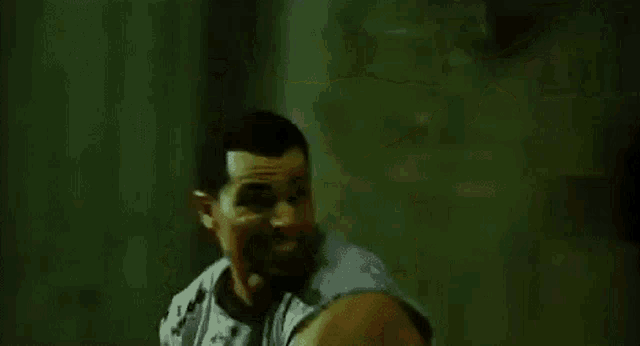 a man and a woman are fighting in a dark room with a bloody sword .