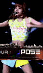a woman is singing into a microphone while standing in front of a sign that says pose .