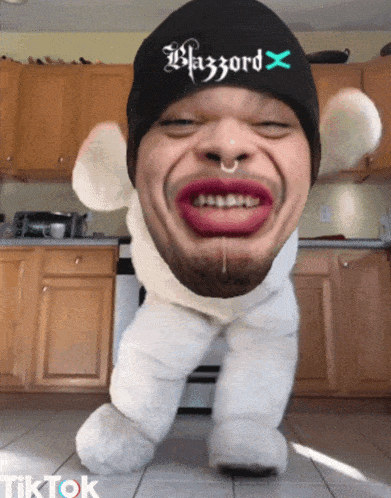 a man wearing a beanie that says blazzard x on it