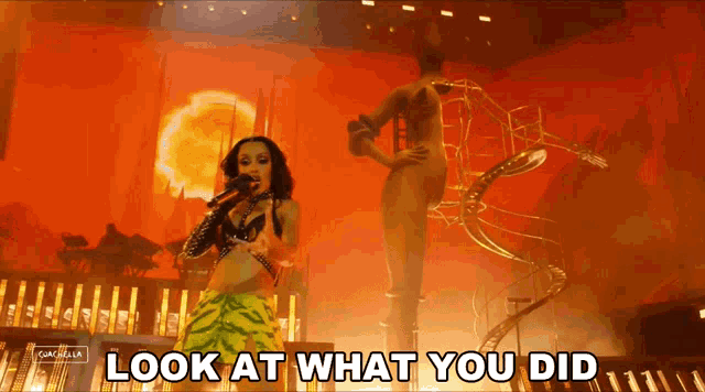 a woman singing on stage with the words look at what you did above her
