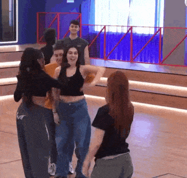a group of people are dancing together in a dance studio