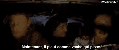 a group of people are sitting in a car with the caption " maintenant il pleut comme vache qui pisse ! "