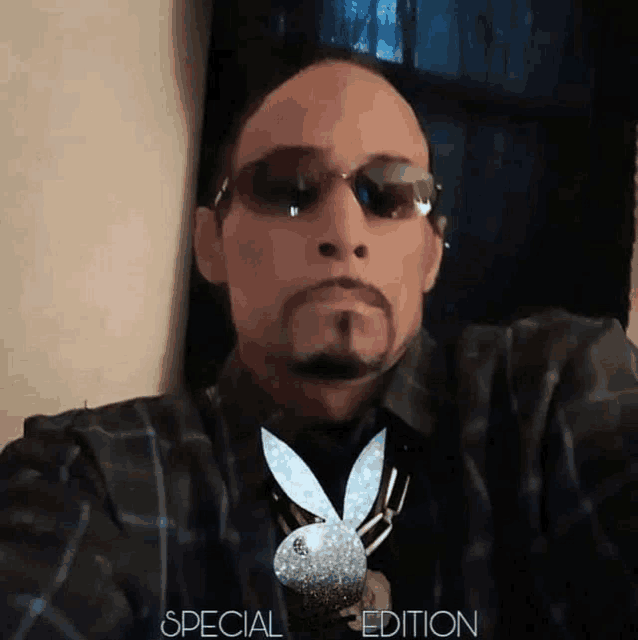 a man wearing sunglasses and a playboy bunny necklace with the words special edition below him