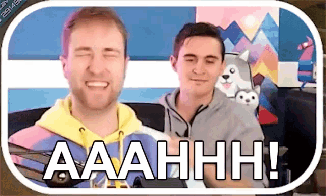 two men are sitting next to each other and one of them is saying aaahhhh