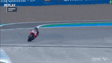 a man riding a motorcycle on a race track with the words replay yesterday sprint at the top