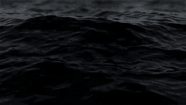 a close up of a black surface of water