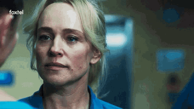 a close up of a woman 's face with the foxtel logo in the background