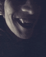 a close up of a person 's face with their mouth open and teeth visible .