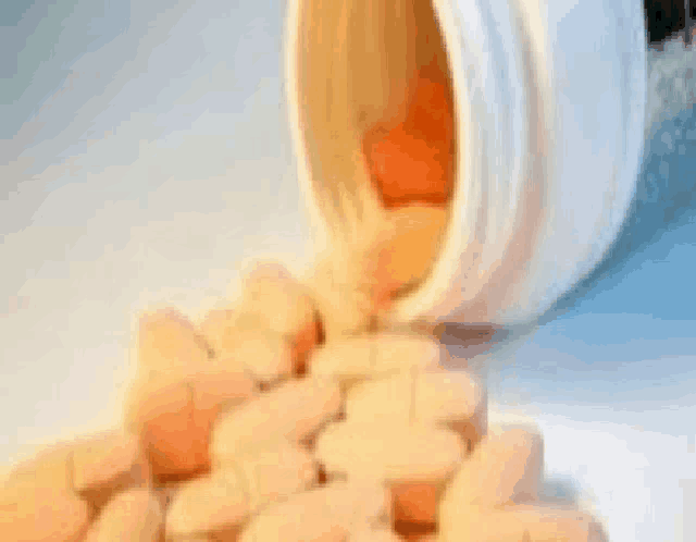 a bottle of pills is pouring out of it onto a pile of pills .