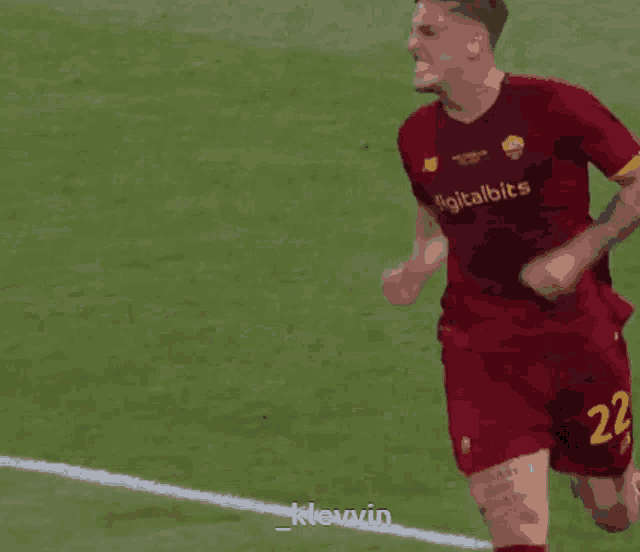 a soccer player wearing a red jersey with digitalbits written on it