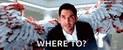 a man in a suit and white shirt with angel wings is asking where to .