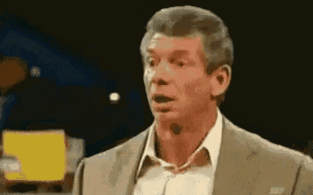 a man in a suit is making a surprised face .