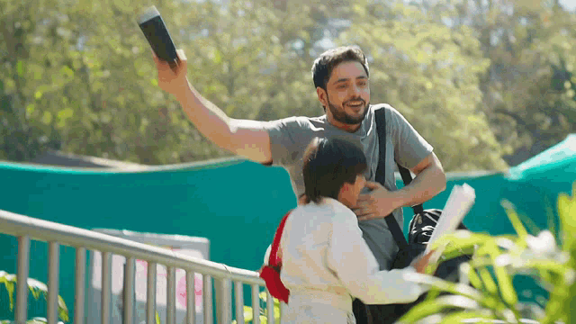 a man is holding a passport and a child is holding papers