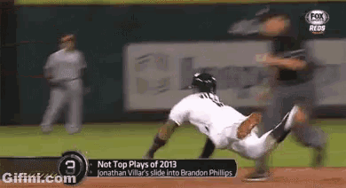 a baseball player is sliding into brandon phillips ' base