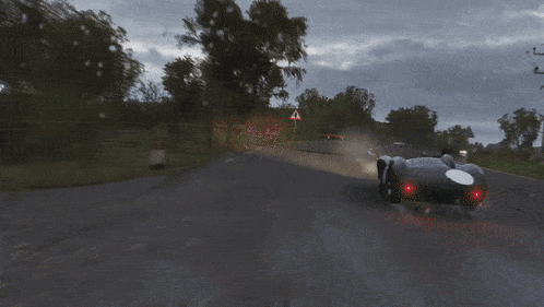a race car is driving down a road with a white number 9 on the side