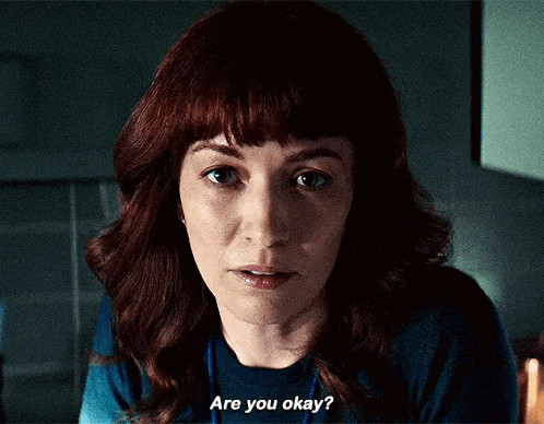 a woman with red hair and bangs is asking if she is okay