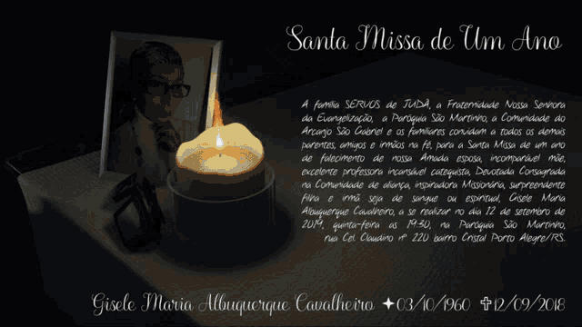 a candle sits on a table next to a photo of gisele maria
