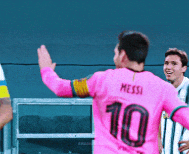 a soccer player wearing a pink jersey with the number 10