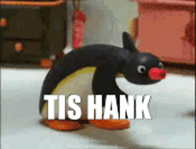 a stuffed penguin with the words tis hank written above it