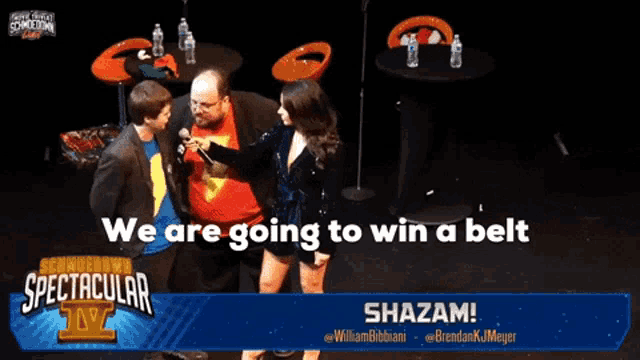a group of people standing on a stage with the words we are going to win a belt behind them