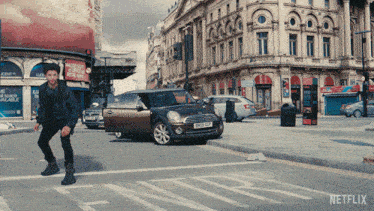 a man crosses a street in front of a sign that says netflix