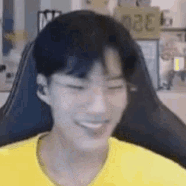 a young man is sitting in a chair and smiling .