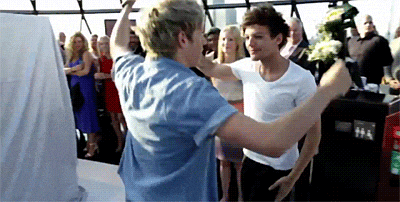 a couple of men are dancing together in front of a crowd of people .