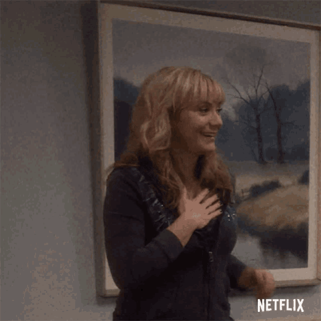 a woman stands in front of a framed painting that says netflix on it