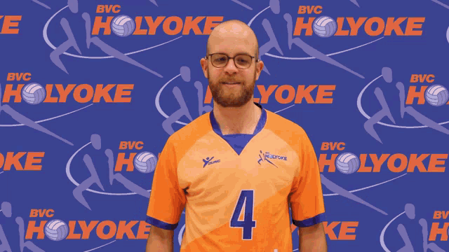 a man wearing an orange jersey with the number 4