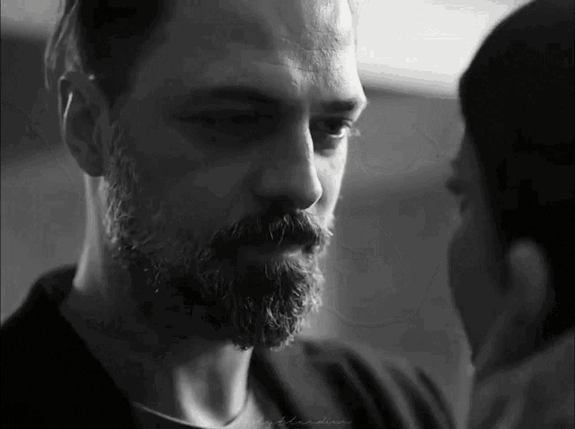 a black and white photo of a man with a beard and a woman