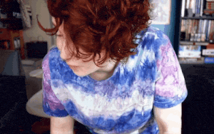 a woman wearing a blue and purple tie dye shirt