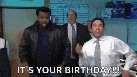 a group of men are dancing in an office with the words `` it 's your birthday '' written on the screen .