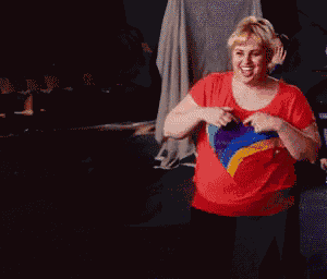 a woman wearing a red shirt with a heart on it