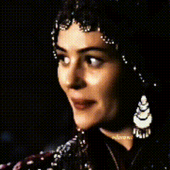 a close up of a woman 's face with earrings