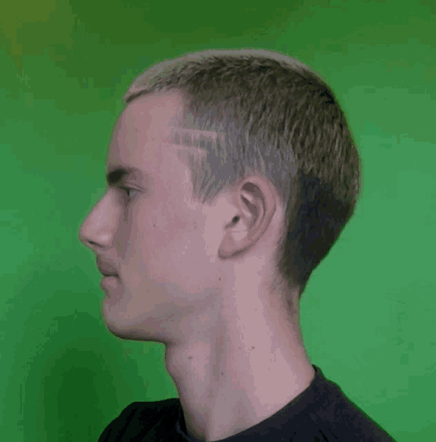 a young man 's head is shown in front of a green screen
