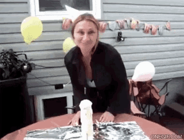 a woman is standing in front of a table with a spray bottle and balloons behind her ..