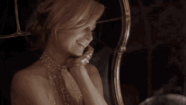 a woman is smiling while talking on a phone