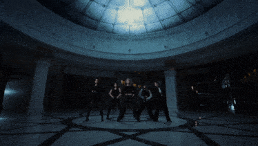 a group of women dance in a dark room