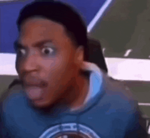 a close up of a man 's face with a surprised look on his face .