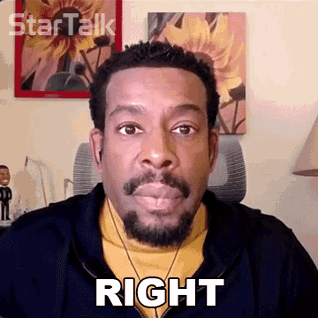 a man with a beard is wearing ear buds and has the word right on his face