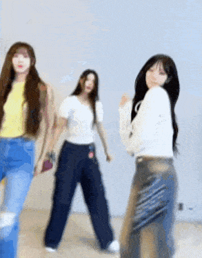 a group of women are dancing together in a room