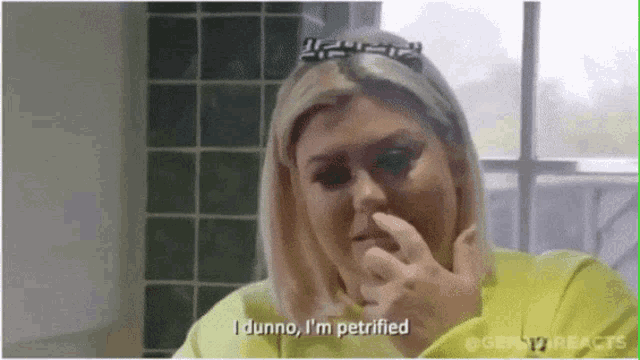 a woman covering her nose with her hand and says i dunno i 'm petrified