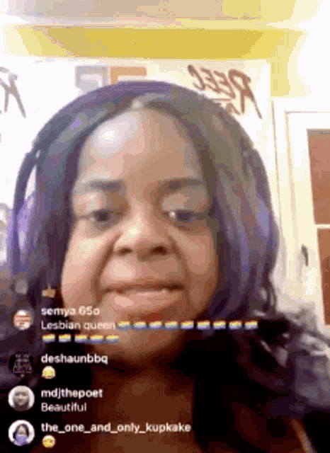 a woman with purple hair is wearing headphones and talking to someone