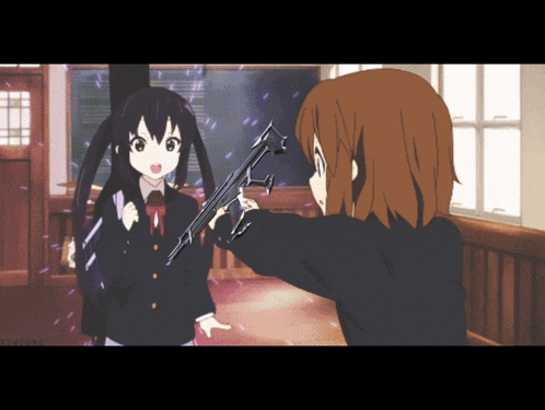 a girl in a school uniform is pointing a gun at another girl in a school uniform