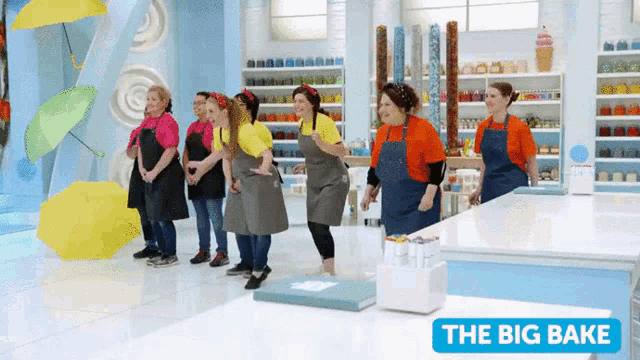 a group of women in aprons are standing in front of a sign that says the big bake