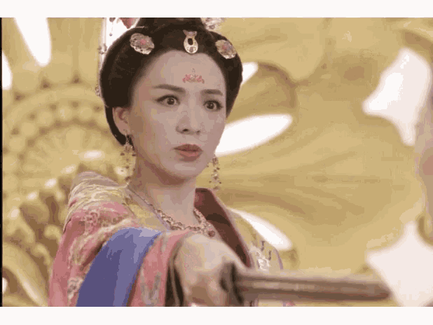 a woman with a crown on her head holds a sword in her hand