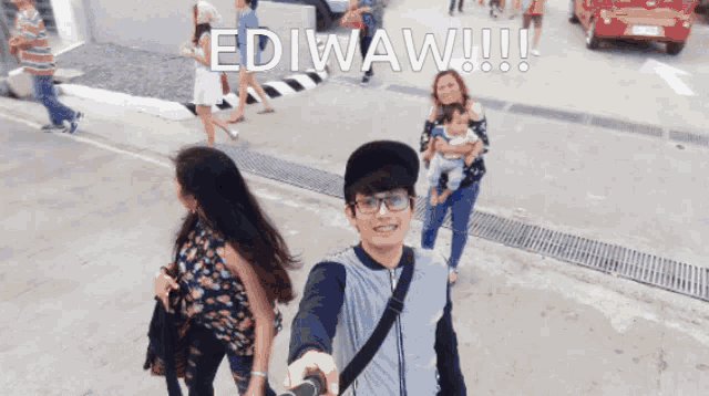 a group of people walking down a street with the words ediwaw written on the top